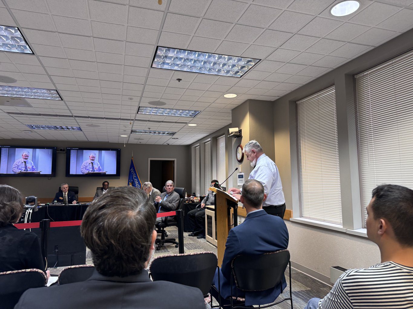 Dan Butkus delivers a WI Lakes statement from a podium in front of the WI Natural Resources Board